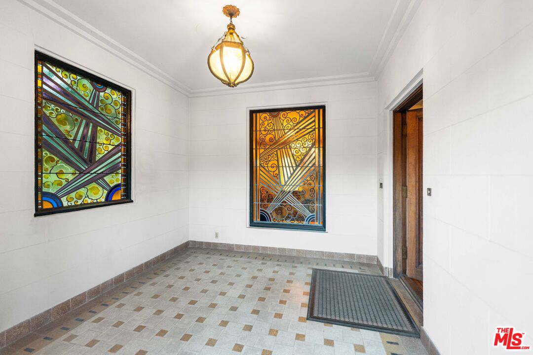 The vestibule featuring two original Art Deco stained-glass windows in jewel tones.